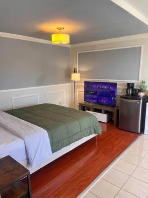 a bedroom with a bed and a flat screen tv at Studio Living,Quiet Neighborhood, Near Airport in Walnut