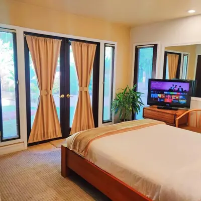 a bedroom with a bed and a flat screen tv at Skyhill Oasis New Lux Designer Modern in Los Angeles