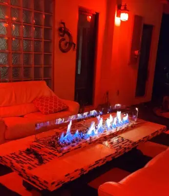 a living room with a table with fires on it at Skyhill Oasis New Lux Designer Modern in Los Angeles