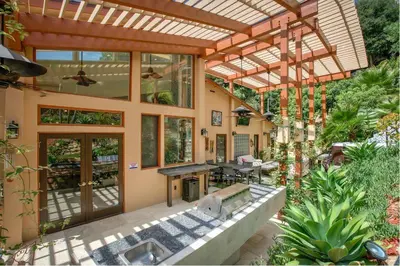 an outdoor patio with a pergola and a table at Skyhill Oasis New Lux Designer Modern in Los Angeles