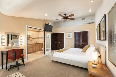a bedroom with a bed and a desk and a fan at Skyhill Oasis New Lux Designer Modern in Los Angeles