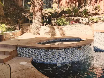 a swimming pool in a backyard with a palm tree at Skyhill Pool - Walk to Universal - Resort-Style Home in Los Angeles