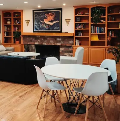a living room with a table and chairs and a fireplace at Skyhill Pool - Walk to Universal - Resort-Style Home in Los Angeles