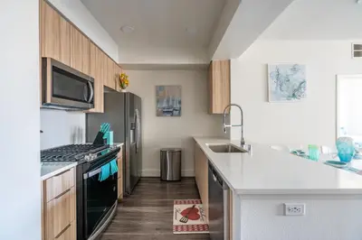 a kitchen with a sink and a stove top oven at Beachside Luxury Apartment I Free Parking in Los Angeles