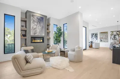 a living room with chairs and a fireplace at Belden Modern Villa in Los Angeles