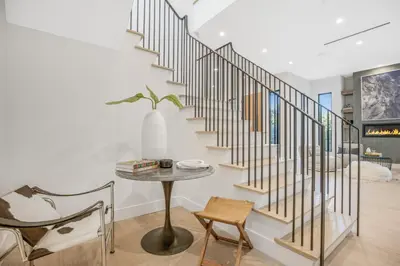 a staircase in a house with a table and chairs at Belden Modern Villa in Los Angeles