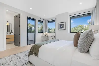 a white bedroom with a large bed and large windows at Belden Modern Villa in Los Angeles