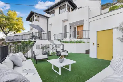 a patio with a white couch and a table at Belden Modern Villa in Los Angeles