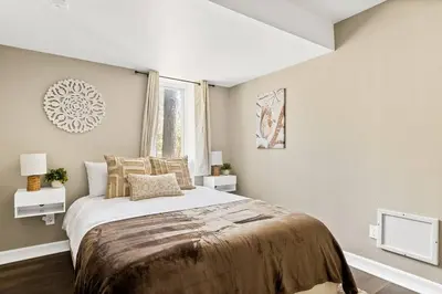 a bedroom with a large bed and a window at Oak Mountain Retreat, Hot Tub, & BBQ, Game Room! in Lake Arrowhead