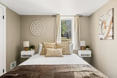 a bedroom with a large bed and a window at Oak Mountain Retreat, Hot Tub, & BBQ, Game Room! in Lake Arrowhead