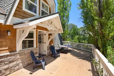 a porch with awning and chairs on a house at Scout's Lakehouse Retreat by Colby & Conrad in Lake Arrowhead