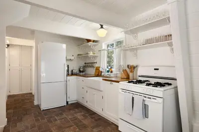 a kitchen with white appliances and a white refrigerator at Scout's Lakehouse Retreat by Colby & Conrad in Lake Arrowhead