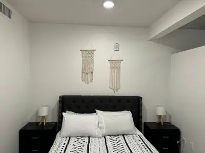 a bedroom with a bed with two night stands and two lamps at Modern and Lavish apartment in Glendale