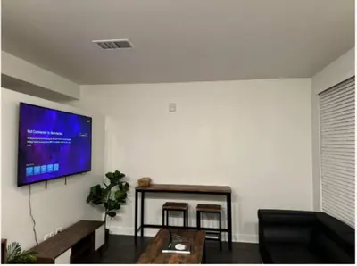 a living room with a flat screen tv on the wall at Modern and Lavish apartment in Glendale
