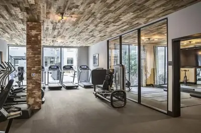a gym with several treadmills and elliptical machines at Stylish and Elegant apartment in Glendale