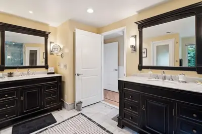 a bathroom with two sinks and two mirrors at Bouquet Cottage home in Thousand Oaks