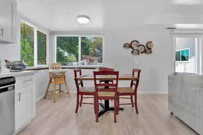 a kitchen and dining room with a table and chairs at Oasis Condo on the Fairway in Victorville