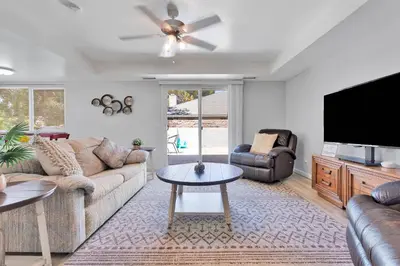 a living room with a couch and a flat screen tv at Oasis Condo on the Fairway in Victorville