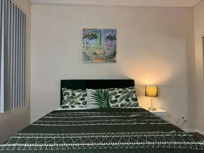 a bedroom with a bed with a black and white bedspread at Travel Haven at Miracle Mile- 110 in Los Angeles