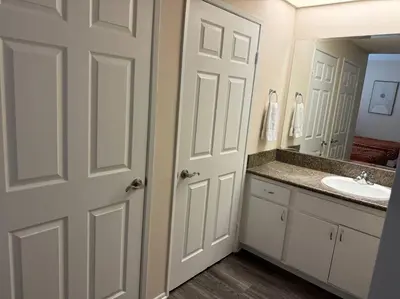 a white bathroom with a sink and a mirror at Travel Haven at Miracle Mile- 110 in Los Angeles