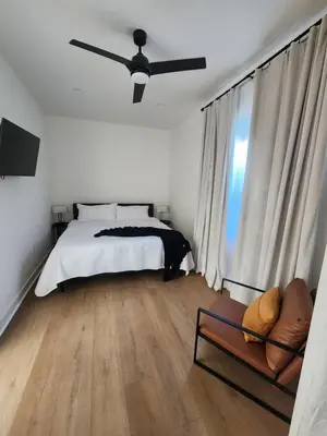a bedroom with a bed and a ceiling fan at Ladera Retreat near Sofi Stadium, LAX, Beach in Los Angeles