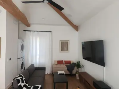 a living room with a couch and a flat screen tv at Ladera Retreat near Sofi Stadium, LAX, Beach in Los Angeles