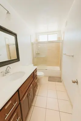 a bathroom with a sink and a toilet and a mirror at Coastal Comfort Homestay in Santa Monica in Los Angeles