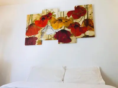 three pieces of art on a wall above a bed at Coastal Comfort Homestay in Santa Monica in Los Angeles