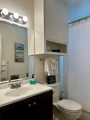 a bathroom with a sink and a toilet and a mirror at The Nest Manhattan Beach, Partial Ocean View in Los Angeles
