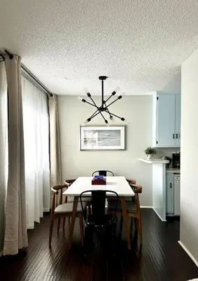 a dining room with a table and a chandelier at The Nest Manhattan Beach, Partial Ocean View in Los Angeles
