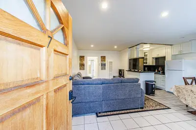 a living room with a blue couch and a kitchen at Gorgeous 1 Bedroom Apartment#7 in Los Angeles