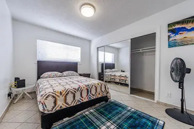 a bedroom with a bed and a fan and a mirror at Gorgeous 1 Bedroom Apartment#7 in Los Angeles