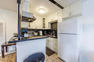 a kitchen with white cabinets and a white refrigerator at Gorgeous 1 Bedroom Apartment#7 in Los Angeles