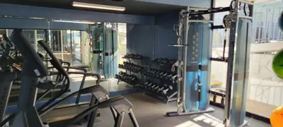 a gym with a row of treadmills at MC Pacific Inn & Suites Torrance in Torrance