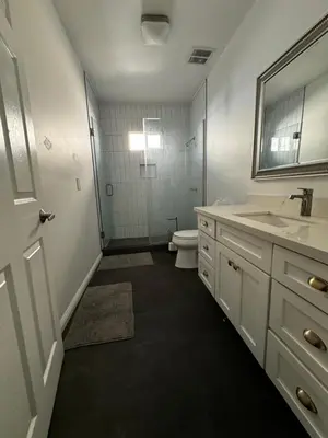 a bathroom with a toilet and a sink and a mirror at Green House in Los Angeles