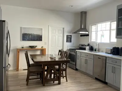 a kitchen with a table and chairs in a kitchen at Green House in Los Angeles