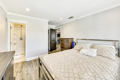 a bedroom with a large bed in a room at Game Room, Pool! Family Home 25 Mi to Disneyland in West Covina