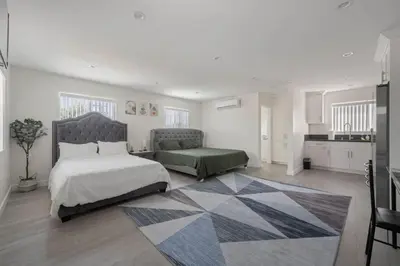 a bedroom with a bed and a couch and a kitchen at Prime new beautiful studio in burbank in Burbank