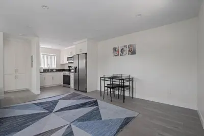 a kitchen with a table and a kitchen with white walls at Prime new beautiful studio in burbank in Burbank
