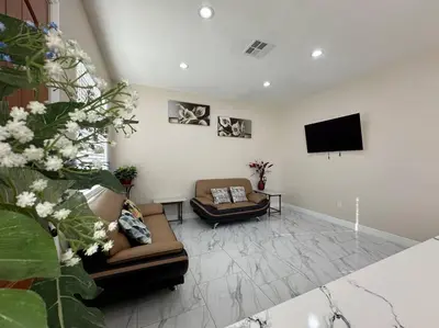 a living room with couches and a flat screen tv at New Renovated House in Little Saigon in Midway City