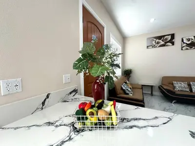 a basket of fruit on a bed in a living room at New Renovated House in Little Saigon in Midway City