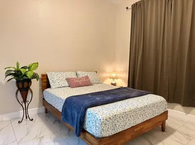 a bedroom with a bed with a blue blanket at New Renovated House in Little Saigon in Midway City
