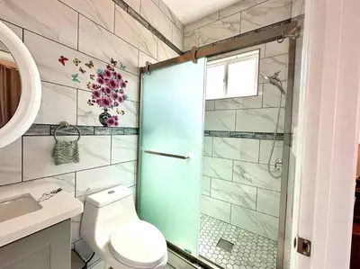 a bathroom with a shower and a toilet and a sink at New Renovated House in Little Saigon in Midway City