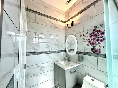a white bathroom with a sink and a mirror at New Renovated House in Little Saigon in Midway City
