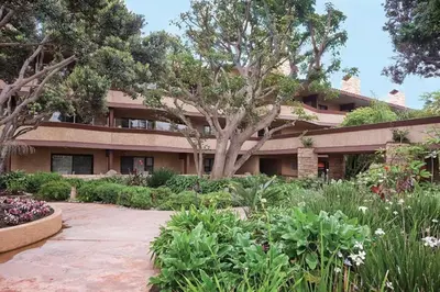 a building with a garden in front of it at Beautiful Resort in Harbortown Point 1BD near Marina Park in Ventura