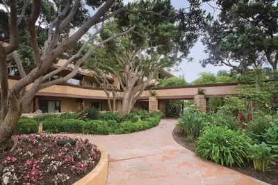 a house with a garden with flowers and plants at Beautiful Resort in Harbortown Point 1BD near Marina Park in Ventura