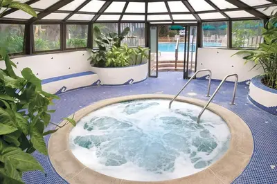 a jacuzzi tub in a greenhouse with plants at Beautiful Resort in Harbortown Point 1BD near Marina Park in Ventura