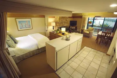a hotel room with a bed and a living room at Beautiful Resort in Harbortown Point ST near Marina Park in Ventura