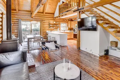 a living room with a couch and a tv at Community Pool Modern Cabin in Pine Mountain Club in Pine Mountain Club