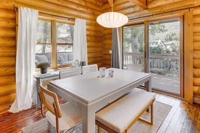 a dining room with a white table and chairs at Community Pool Modern Cabin in Pine Mountain Club in Pine Mountain Club